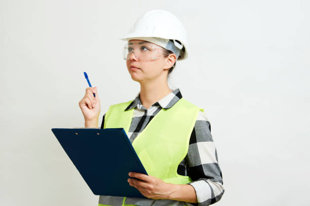 istock Portrait of female construction worker on white background 1324011307