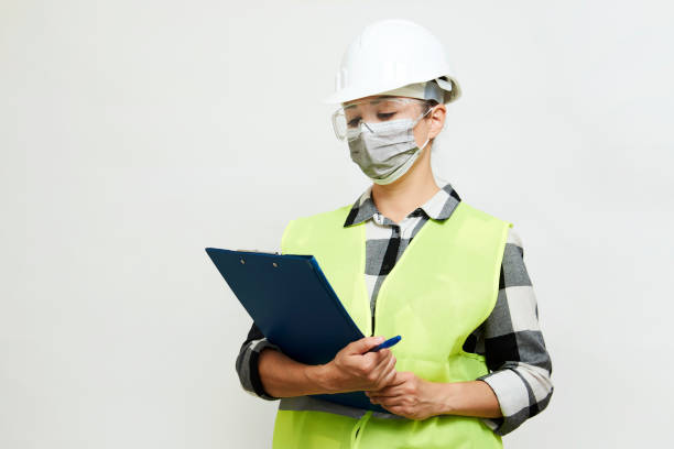 istock Engineer woman worker with hard hat and paper clipboard 1324011316