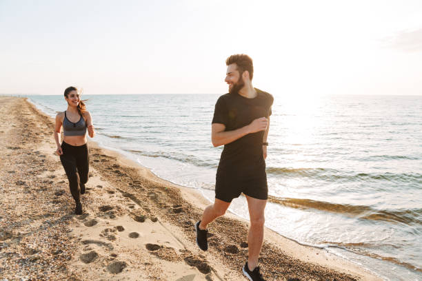 istock Attractive young couple jogging together 1324011454