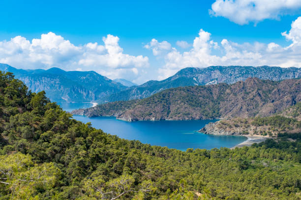 Mediterranean region.Sea mountain landscape,clouds Mediterranean region.Sea mountain view,clouds.Heart-shaped cove.forestHeart shaped bay.Mountain Moses in the background, Olympos region.Forest sea, mountain cloud intertwined landscape photo aegean islands stock pictures, royalty-free photos & images