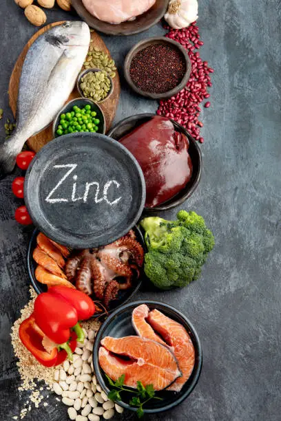 Food high in zinc on dark background. Healthy eating concept. Top view, flat lay, copy space