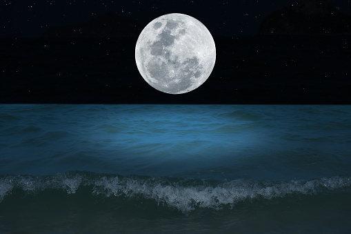 Full moon on sky over sea in the night.