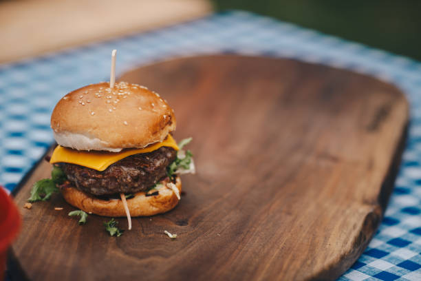 istock Tasty hamburger on chopping board. Copy-space. 1324016375