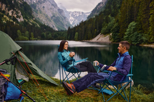 istock An adventurous young couple at their campsite and drinking coffee 1324016824
