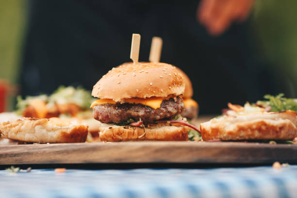 istock Hamburger and hot dogs on wooden board. 1324018446