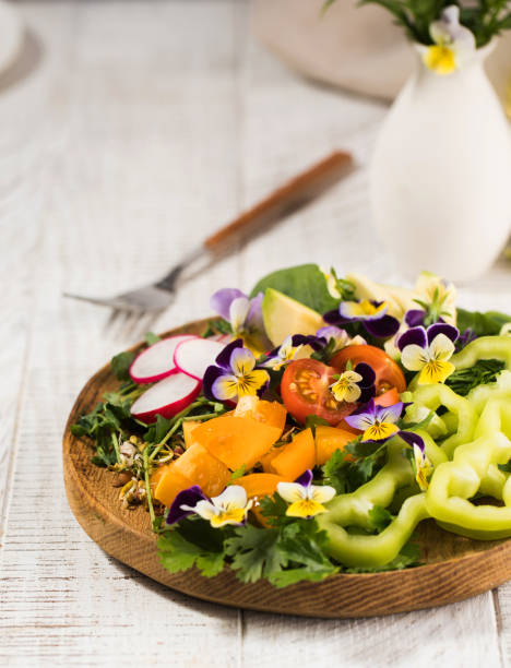 Vegetable summer salad decorated with edible flowers. Summer dish, summer menu.High quality photo
