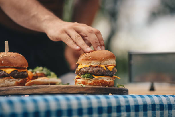 istock Chef preparing hamburgers outdoors. 1324019316
