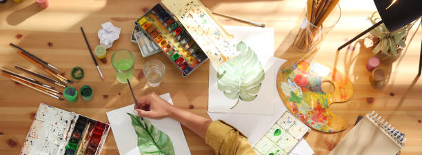 istock Young woman drawing at table indoors, top view. Banner design 1324019745