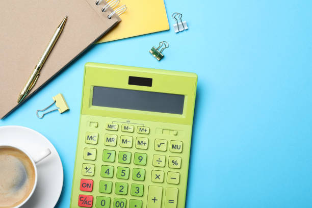istock Flat lay composition with calculator and stationery on light blue background, space for text 1324020664