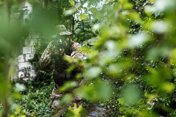 istock Camouflaged warrior walking with rifle 1324020953