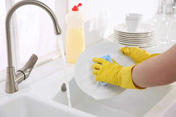 istock Woman washing plate in modern kitchen, closeup 1324021176