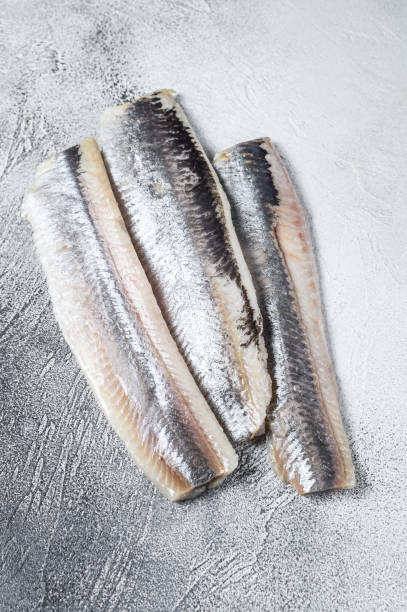 istock Pickled marinated sea herring fillet. White background. Top view 1324021303
