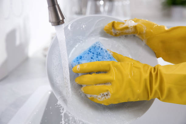 istock Woman washing plate in modern kitchen, closeup 1324022209