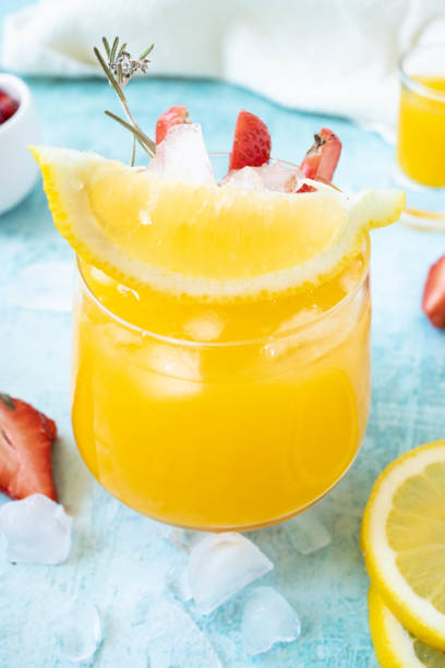 istock Portion of fresh made Orange Juice on blue background 1324022360
