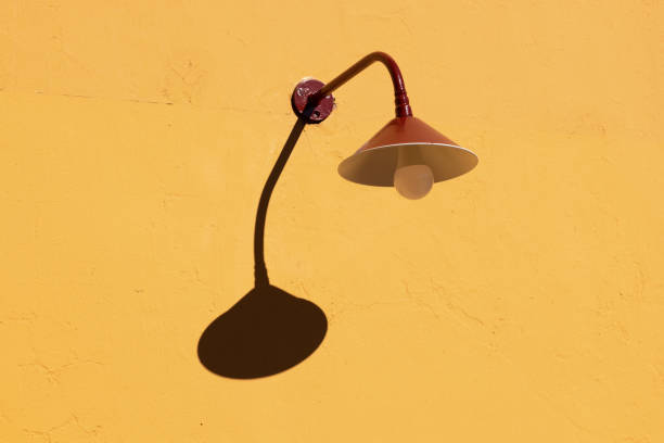 Old street light on a yellow wall.