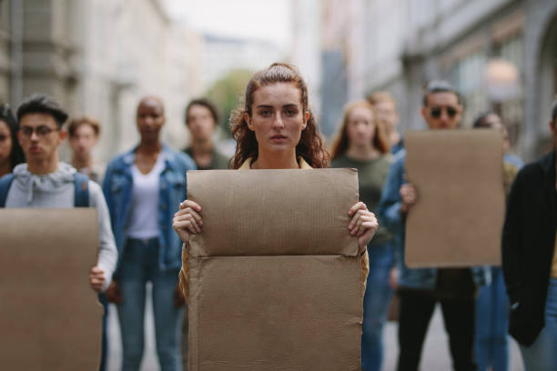 istock People demonstrating with blank placards 1324026969