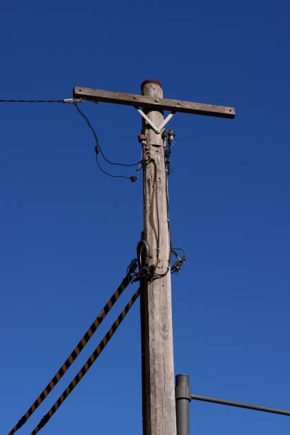 istock Wooden telegraph pole against a blue sky 1324027049