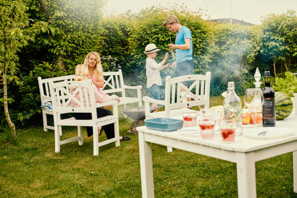 istock Family dining in their garden baking bread over open bonfire 1324027082