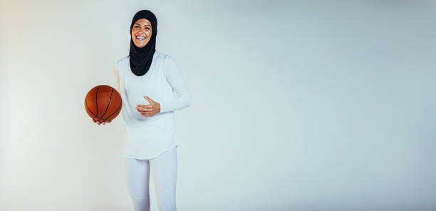 istock Smiling female athlete playing basketball 1324027699