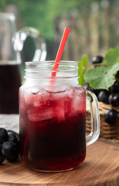 istock Glass of Grape Juice With Fresh Grapes 1324028325