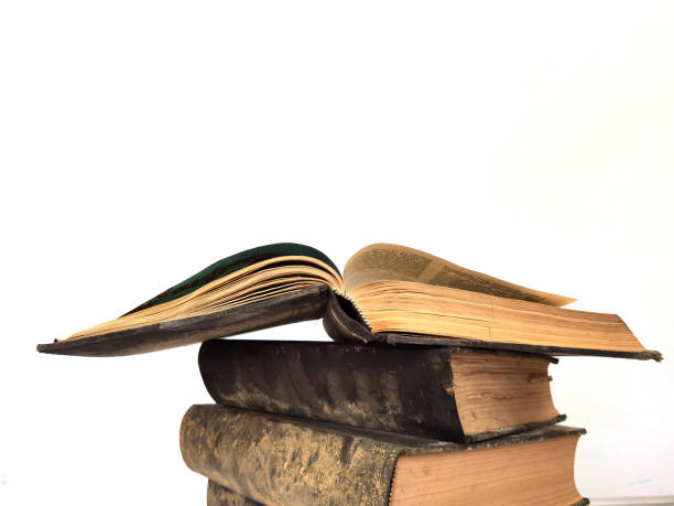 istock books book  old aged  in the dust pile stack isolated for background 1324029716
