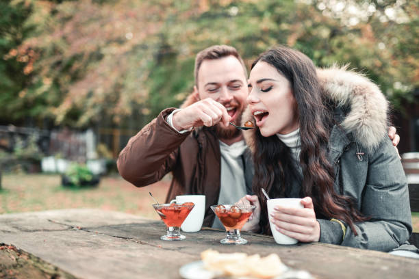 istock Couple Enjoying Warm Slatko And Tea During Forest Vacation 1324029866