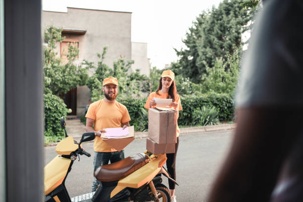 istock Delivery Couple Bringing Packages To Owner On Scooter 1324030430