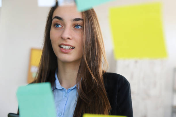 istock Business woman looking at sticky notes 1324030598