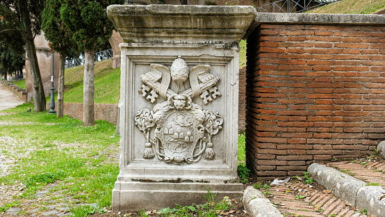 Rome, Adrian Park. Vatican shields like this are seen at the edge of the park.