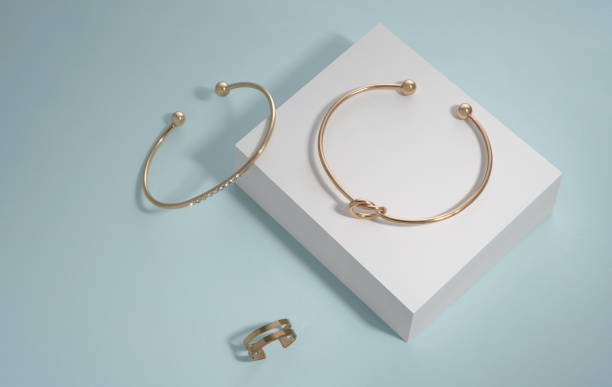 istock Modern design golden jewelries on white box on blue background with copy space 1324031216
