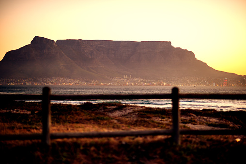 Scenic view of the city of Cape Town against the backdrop of Table Mountain at sunset in summer