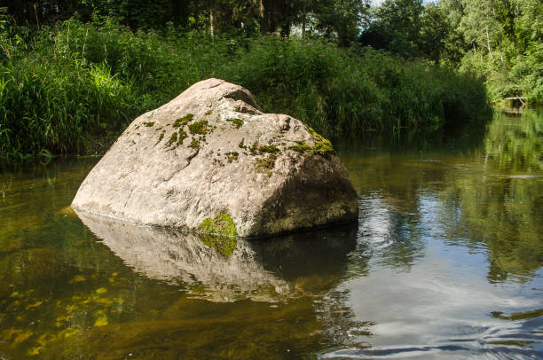 istock Large stones in the river Ciecere, Latvia 1324034306