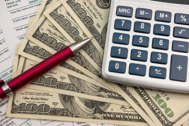 istock US dollars bills and calculator 1324035830