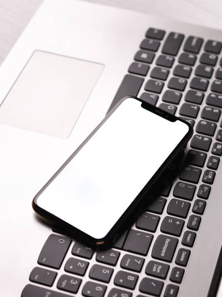 istock Mockup of mobile phone with blank screen on desk table. Flat lay, top view. 1324036580