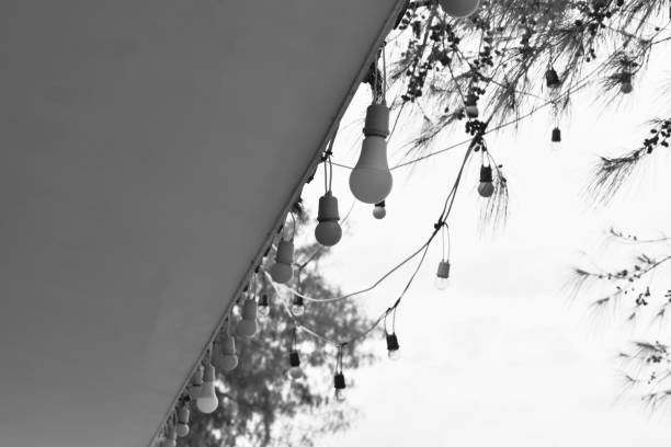 decoration lamp hanging from rooftop of building in black and white tone