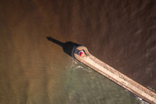 istock Bird's Eye View of a Lighthouse and Breakwater 1324039945