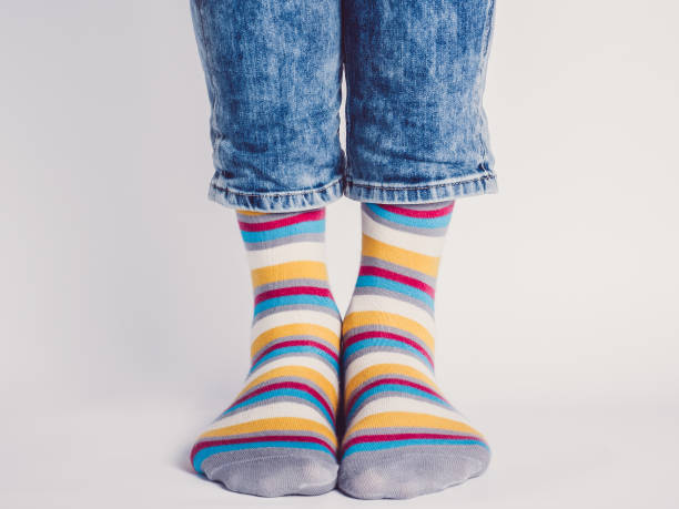 istock Men's legs and bright socks. Without shoes 1324040551
