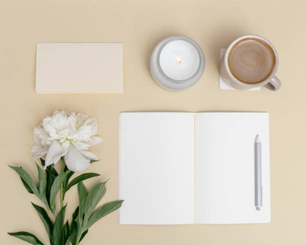 istock Flat lay office table desk. Workspace with blank copybook, pen, cup of coffee, white peony flower and fragrant candle as aromatherapy 1324040701