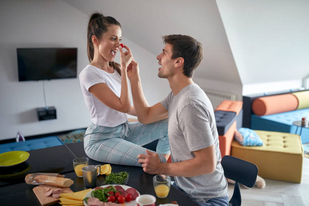 istock A young couple playing while having a breakfast at home. Love, together, breakfast, home 1324040754