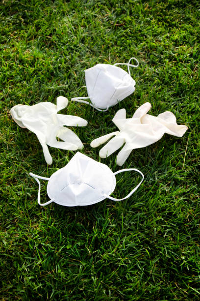 istock Anti Covid-19 masks thrown on the ground creating pollution. 1324040968
