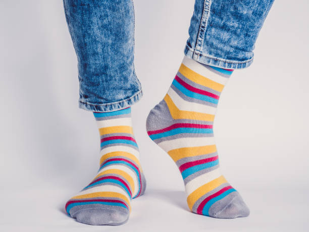 istock Men's legs and bright socks. Without shoes 1324041220