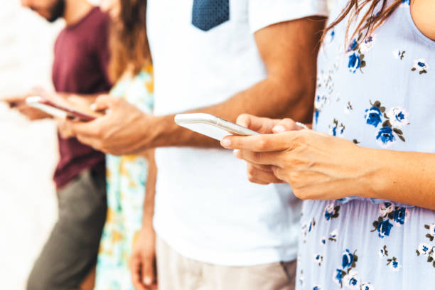 istock Group of friends using smartphone outdoors - Young people spend time together with internet - technology and social network addiction with mobile phones concept. 1324041367