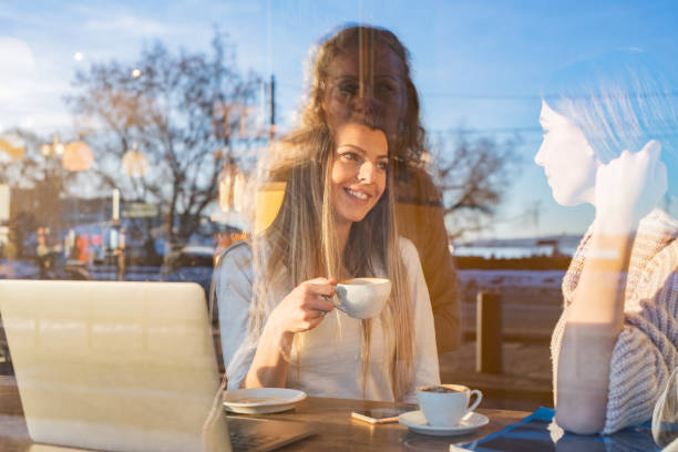istock Two female friends talking in coffee bar 1324042306