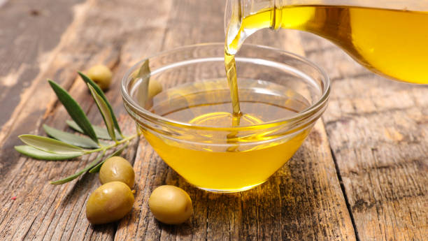 istock olive oil pouring in bowl 1324042511