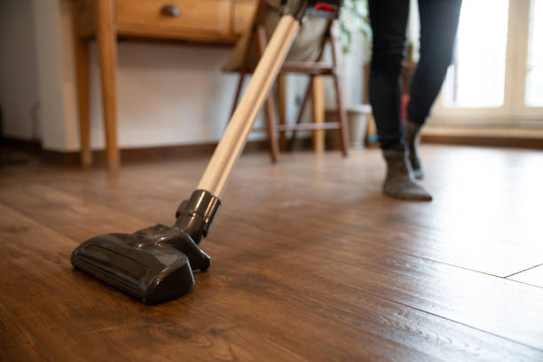 istock Woman cleaning with vacuum cleaner 1324043540