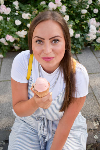 istock Woman outdoors holding ice cream 1324044587