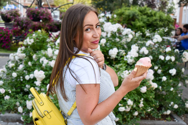 istock Woman outdoors holding ice cream 1324044810
