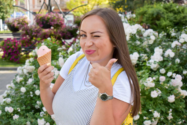 istock Woman outdoors holding ice cream 1324044828
