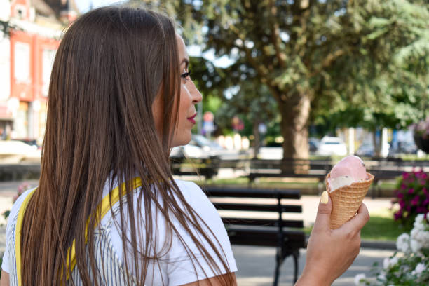istock Woman outdoors holding ice cream 1324044862