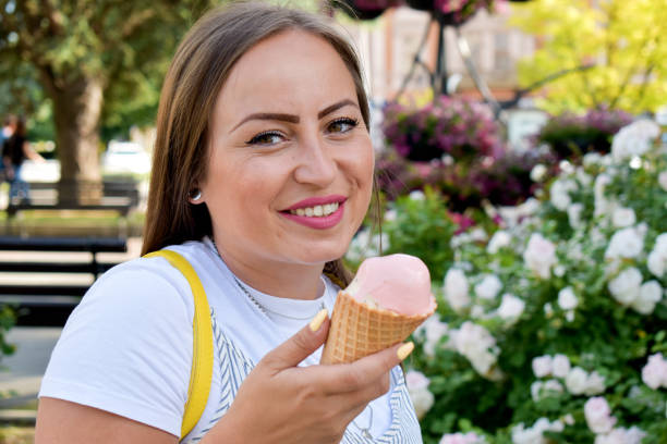 istock Woman outdoors holding ice cream 1324045491